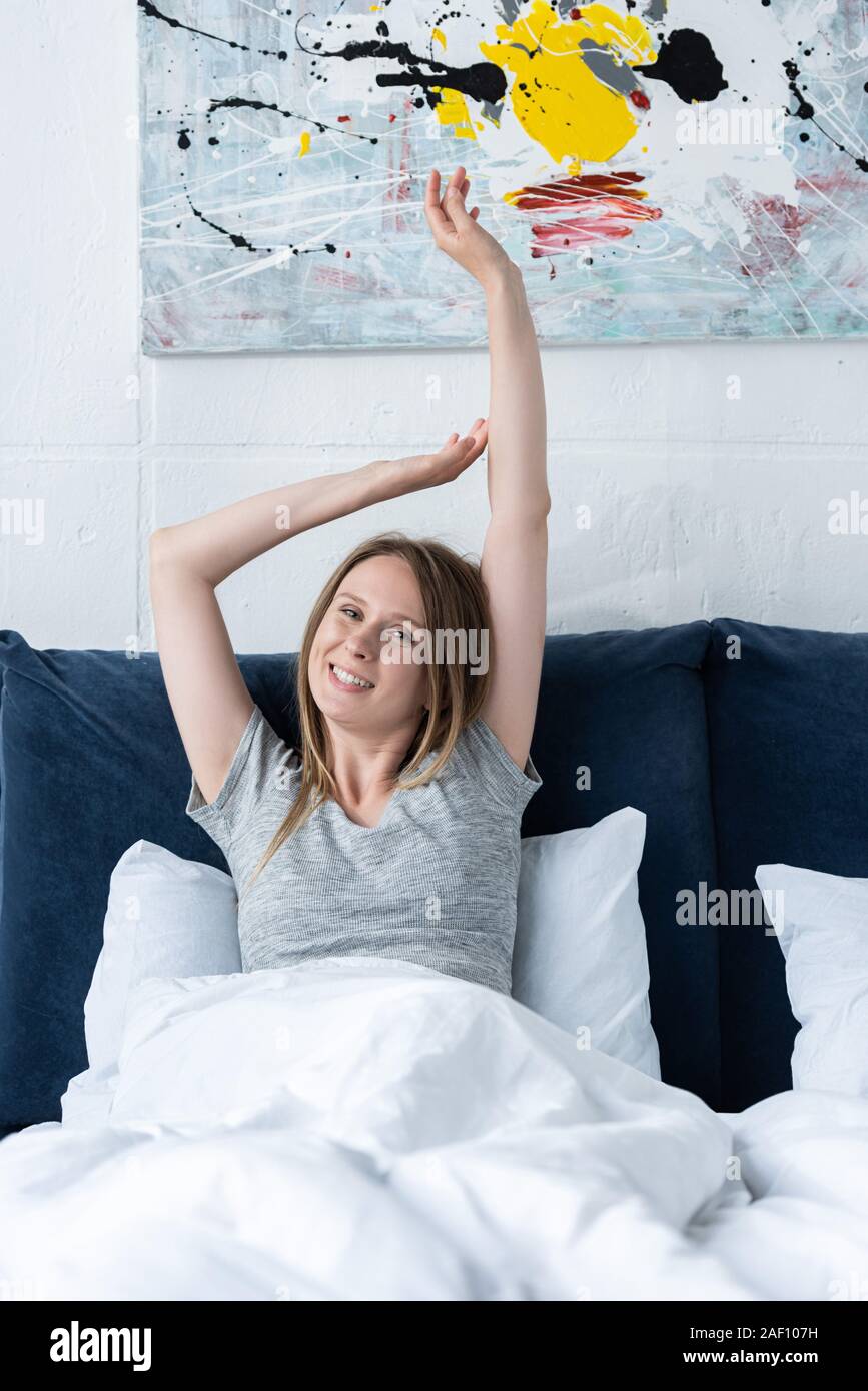 Happy young woman in bed hi-res stock photography and images - Alamy