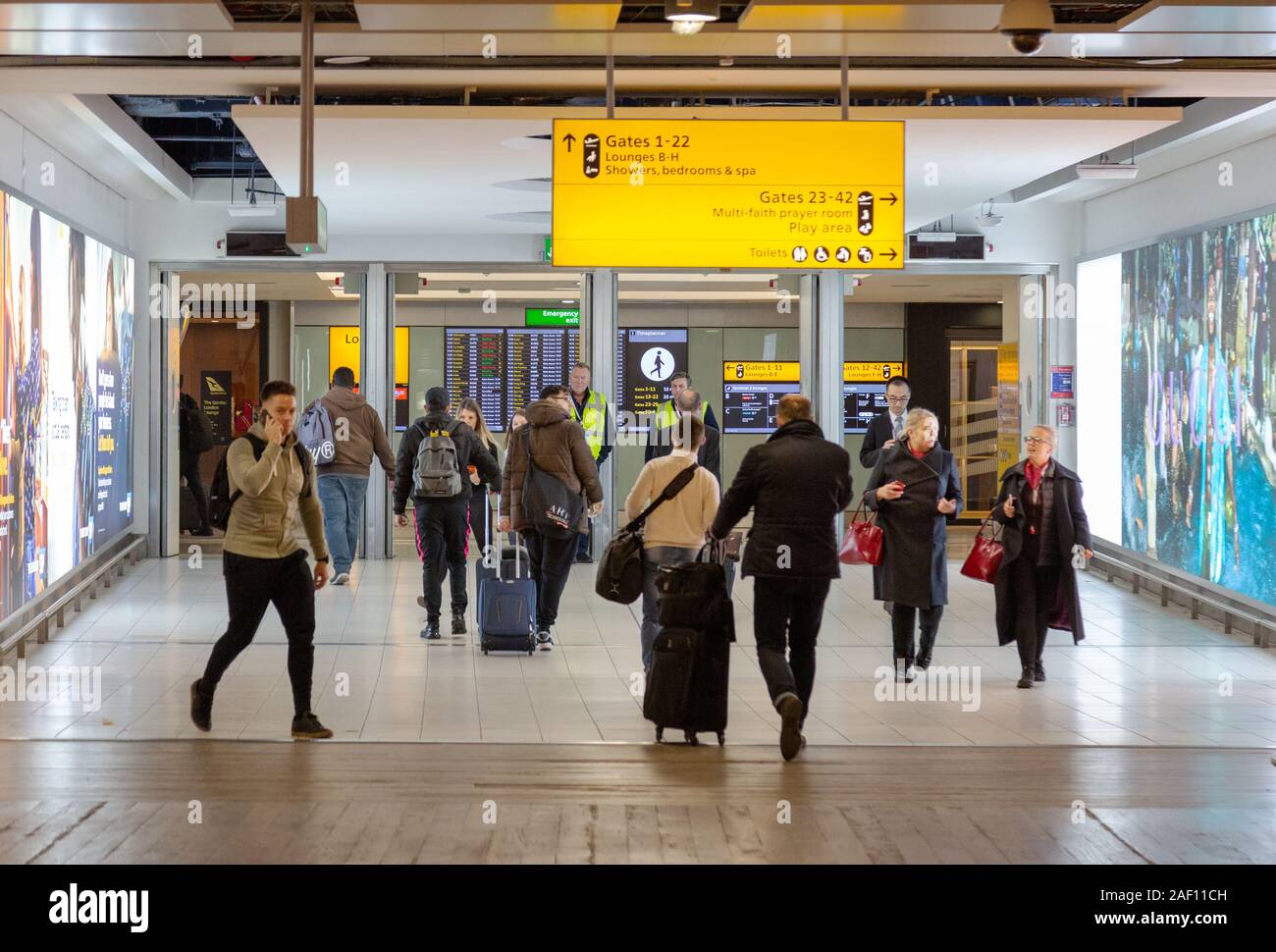 Heathrow terminal 3 interior; People going to the gate, Heathrow airport London UK Stock Photo