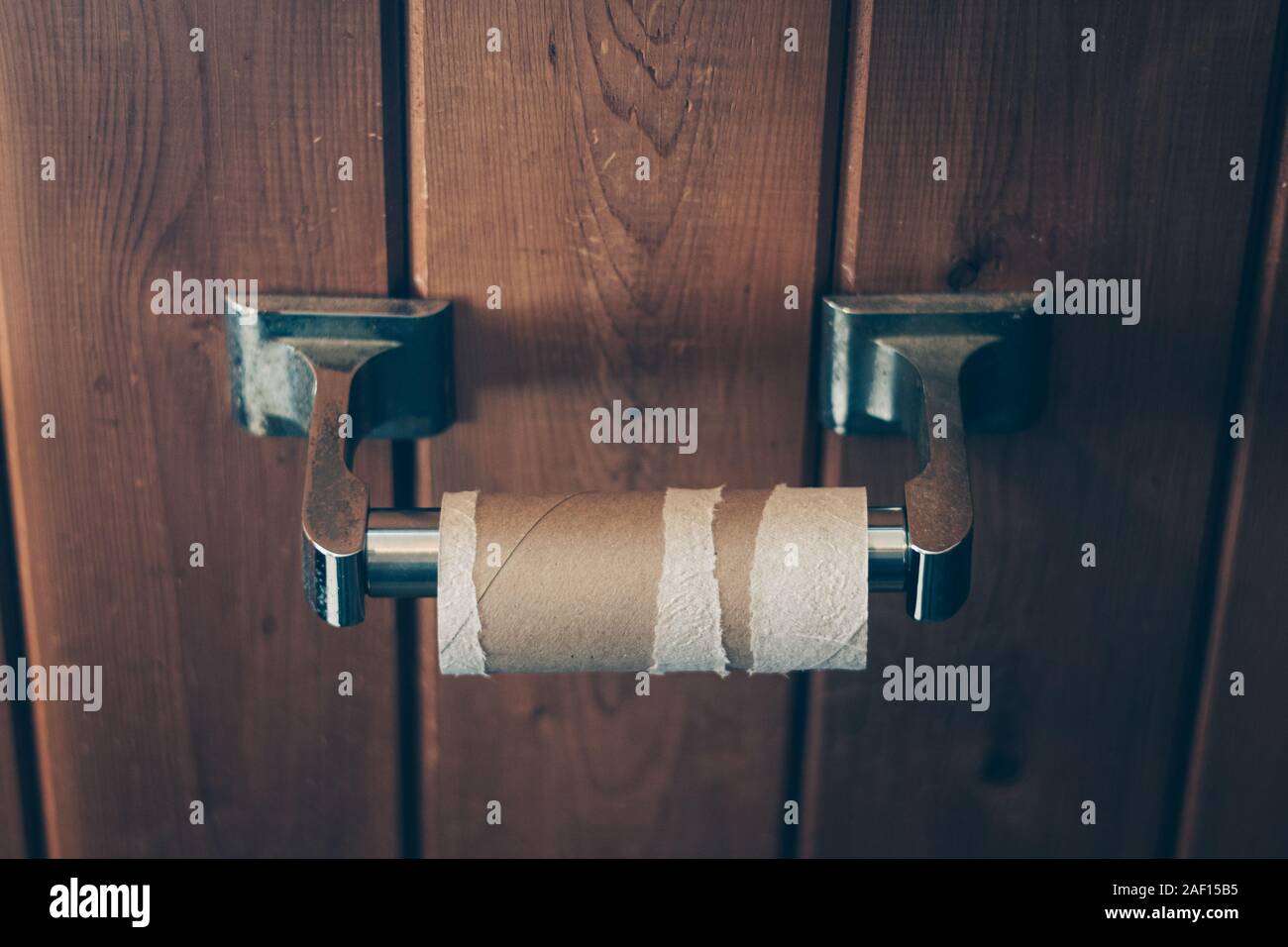 Empty Toilet Paper Roll on Wall Stock Photo