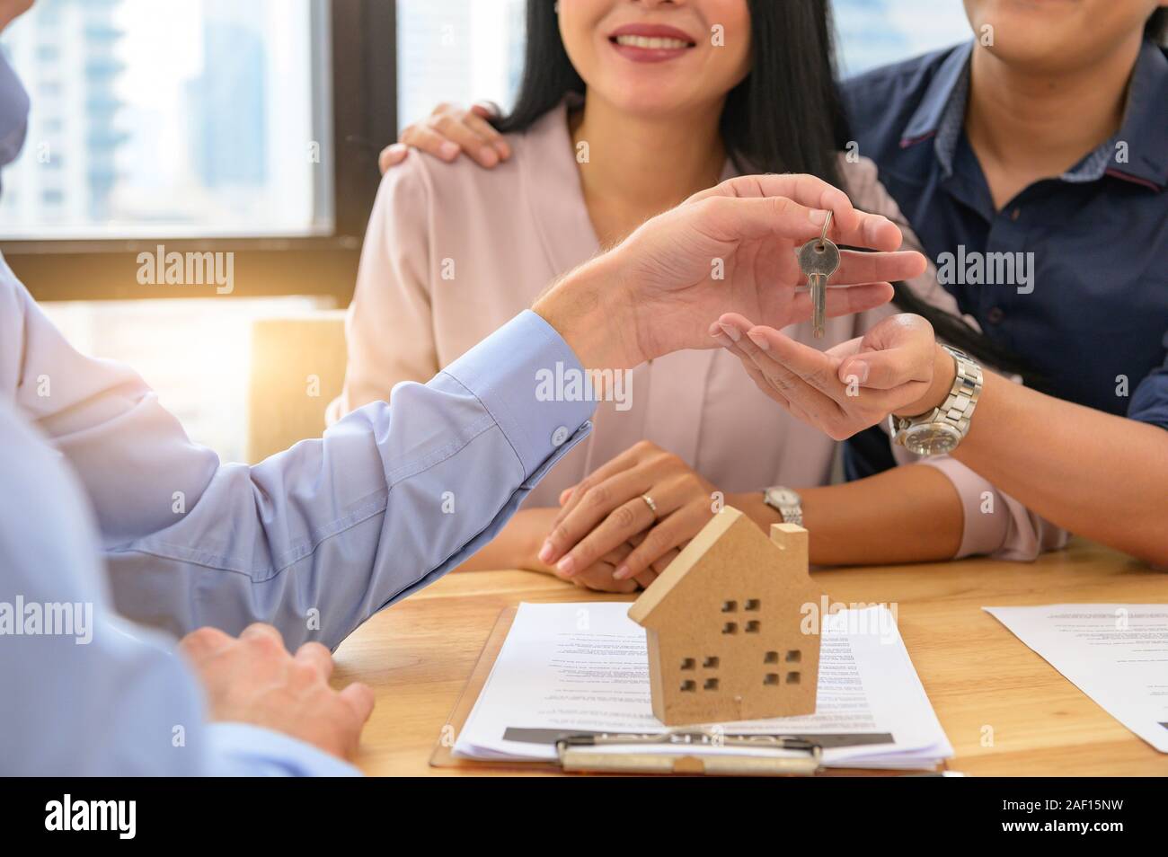 Real estate broker agent offer private home to customer before sign contract agreement documents for rental house property. Ownership realty purchase. Stock Photo