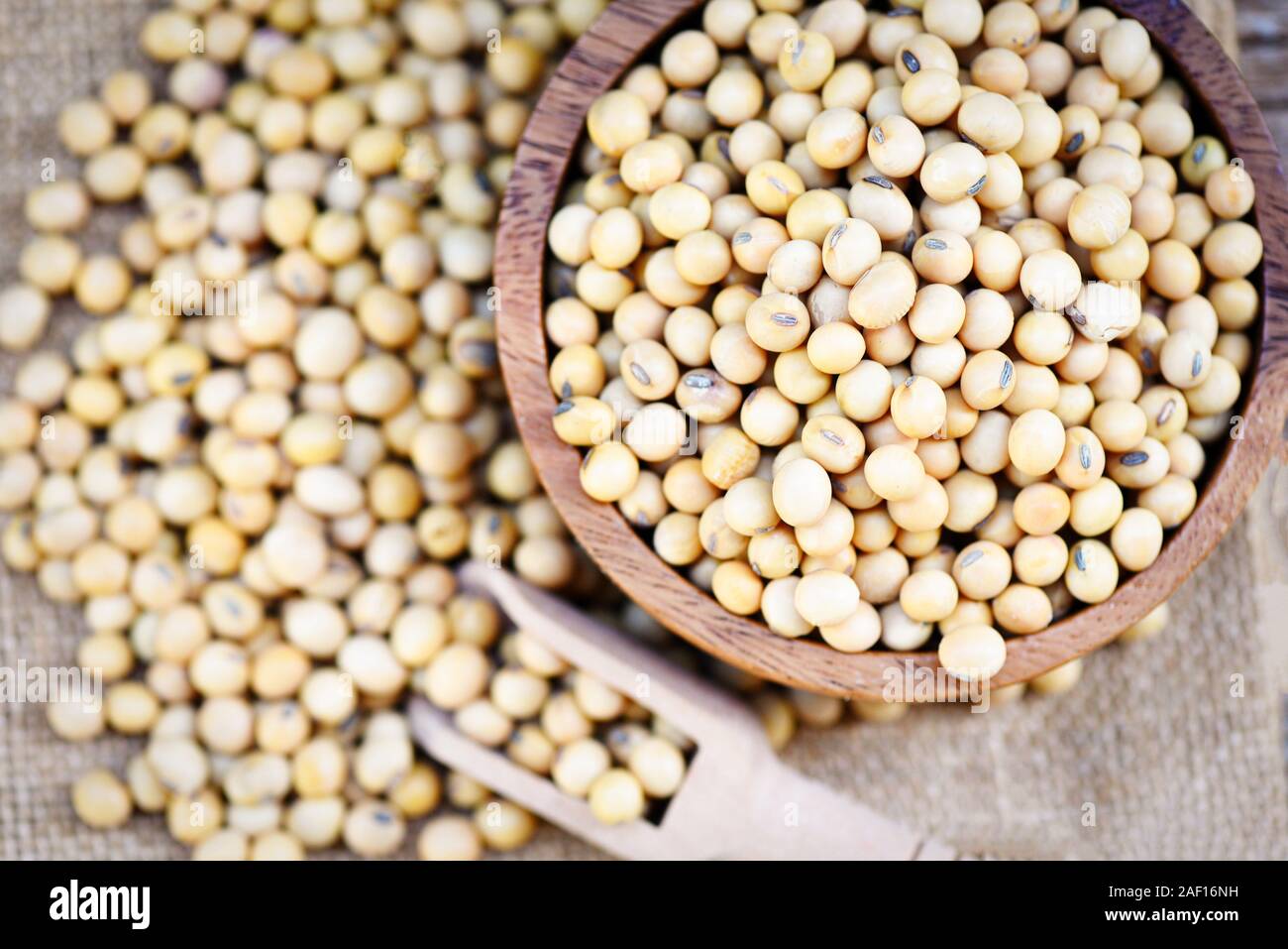 Soybean on bolw and the sack background top view / dry soy beans , soya