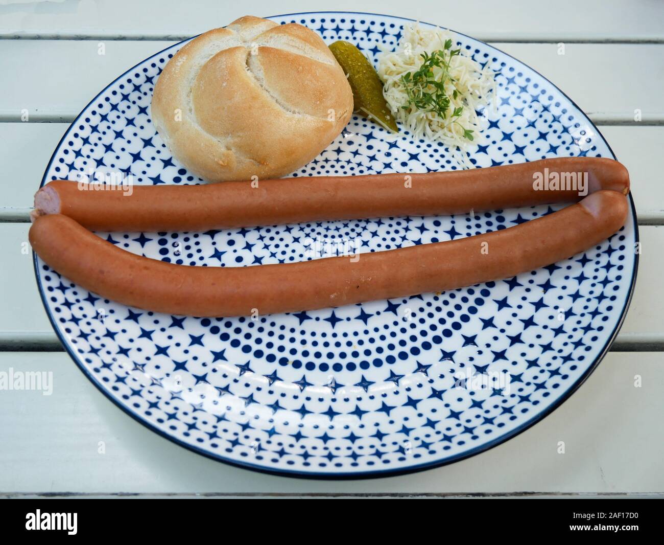 Two Sausages on a plate at jausen station restaurant in the gardens of