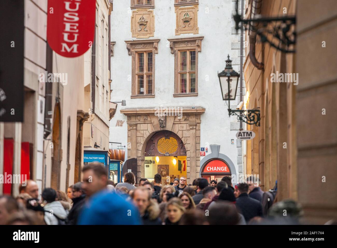 PRAGUE, CZECHIA - NOVEMBER 3, 2019: Crowd of tourists passing by and rushing in a narrow street being overpopulated in the medieval old town of Vienna Stock Photo