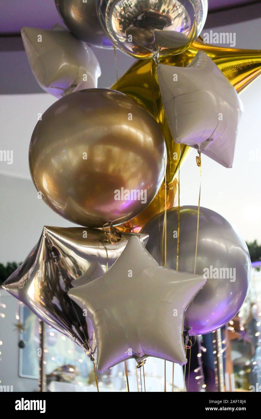 Shiny decorative ribbons hanging from helium balloons Stock Photo