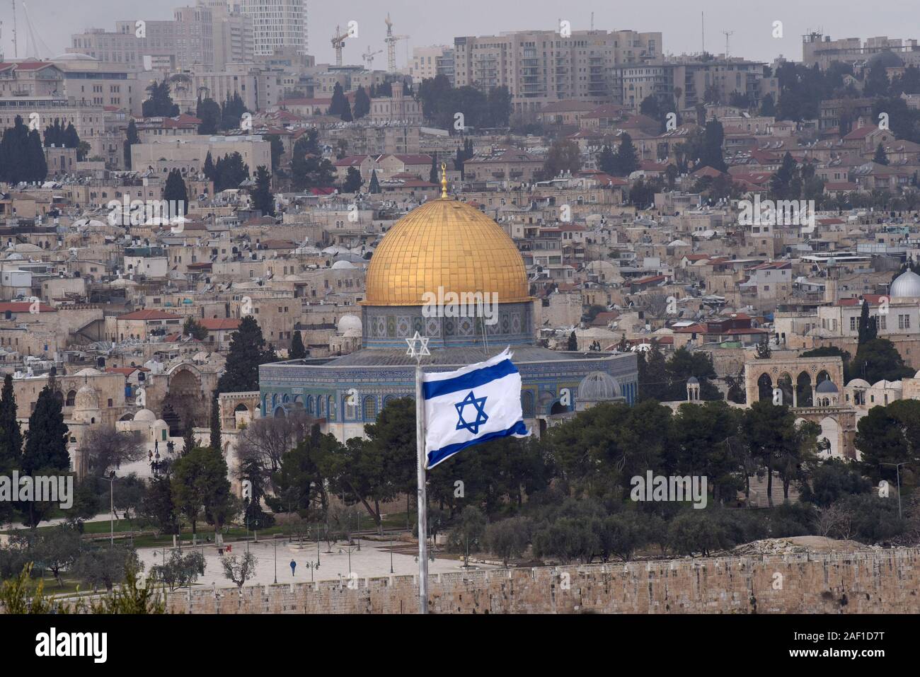 East Jerusalem, Israel. 12th Dec, 2019. An Israeli national flag flies on the Mt. of Olives overlooking the Dome of the Rock in the Old City of Jerusalem in East Jerusalem, January 17, 2019. Israeli television news reported yesterday that U.S. President Donald Trump's Middle East Peace Plan will include territorial swaps in most West Bank territories and a Palestinian capitol in East Jerusalem. Photo by Debbie Hill /UPI Credit: UPI/Alamy Live News Stock Photo