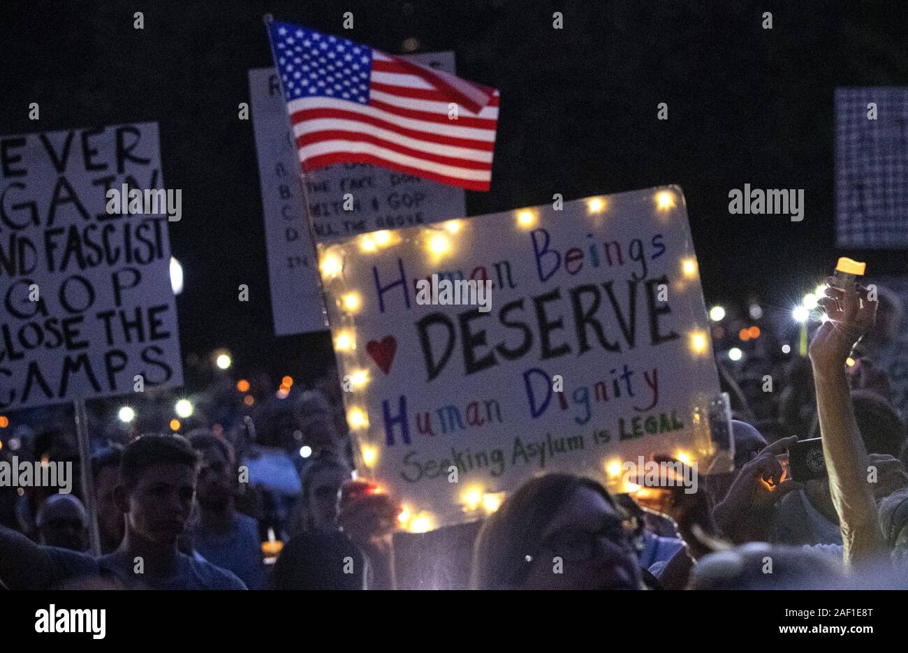 Washington, United States. 12th Dec, 2019. Protesters voice their opinion to the human detention camps on the United States-Mexico border with a candlelight vigil during 'Lights for Liberty' rally in Lafayette Square across the street from the White House in Washington, DC on Friday, July 12, 2019. The rally was part of a nationwide protest against the treatment of immigrants in detention centers and to mark the deaths of eight refugee children in the camps or at the border. Photo by Pat Benic/UPI Credit: UPI/Alamy Live News Stock Photo