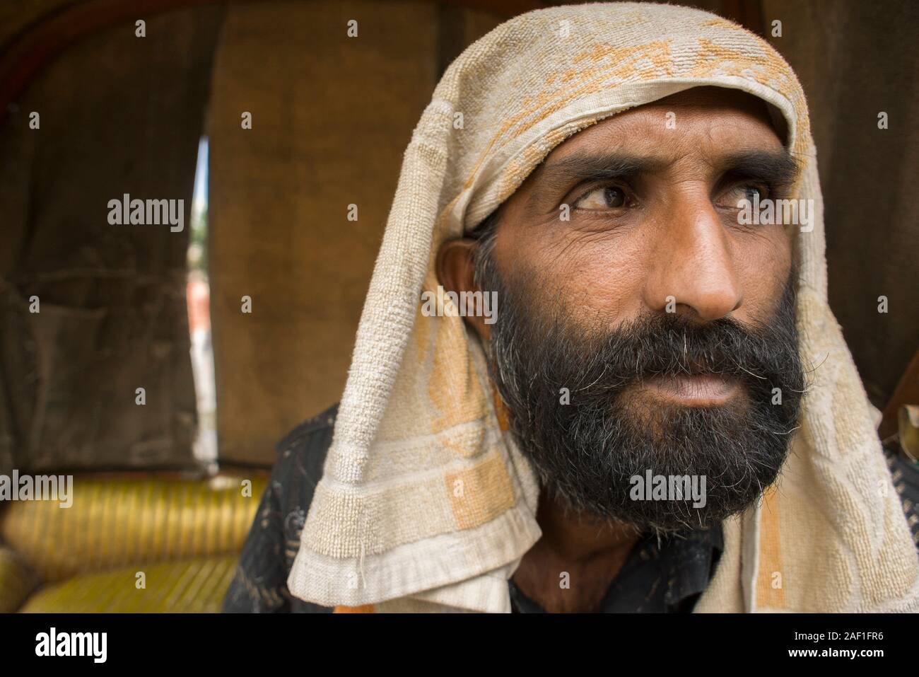 Amritsar, Punjab, India - August 04, 2011: Rickshaw Indian driver with very expressive and exotic face, seated on his vehicle Stock Photo