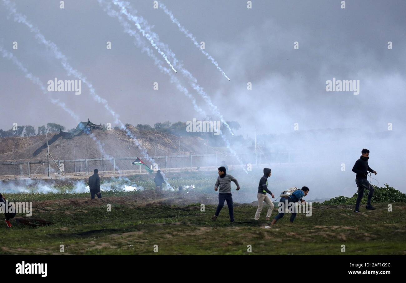 Gaza, Gaza. 12th Dec, 2019. Palestinian demonstrators run away from teas gas canisters fired by Israeli forces during a protest at the Israel-Gaza border fence, east of Gaza City on March 1, 2019. A UN probe released Thursday said Israel might have committed crimes against humanity in responding to last year's unrest in Gaza, as snipers 'intentionally' shot civilians, including children. Israel rejected the report saying that Hamas uses civilians as shields. Photo by Ismael Mohamad/UPI Credit: UPI/Alamy Live News Stock Photo
