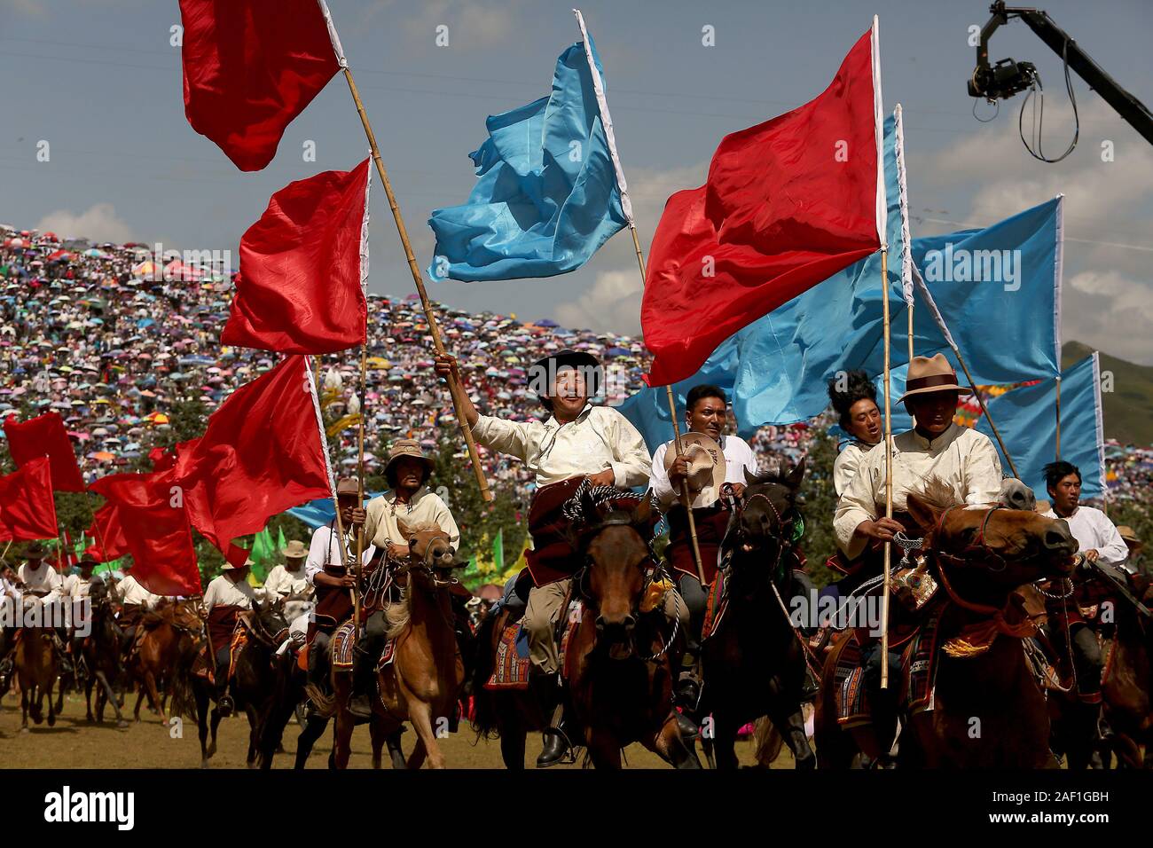 Gannan, China. 12th Dec, 2019. Mounted Tibetans open the year's biggest event, a regional ethnic minority performance, which celebrates the opening of the Dunhuang Silk Road International Tourism Festival being held in Gannan, a major city in Gansu Province's Tibetan Autonomous Region, on Tuesday, August 30, 2019. The area is a key part of China's massive Belt and Road Initiative, where future development will help alleviate poverty and improve education in the Tibetan region. Photo by Stephen Shaver/UPI Credit: UPI/Alamy Live News Stock Photo