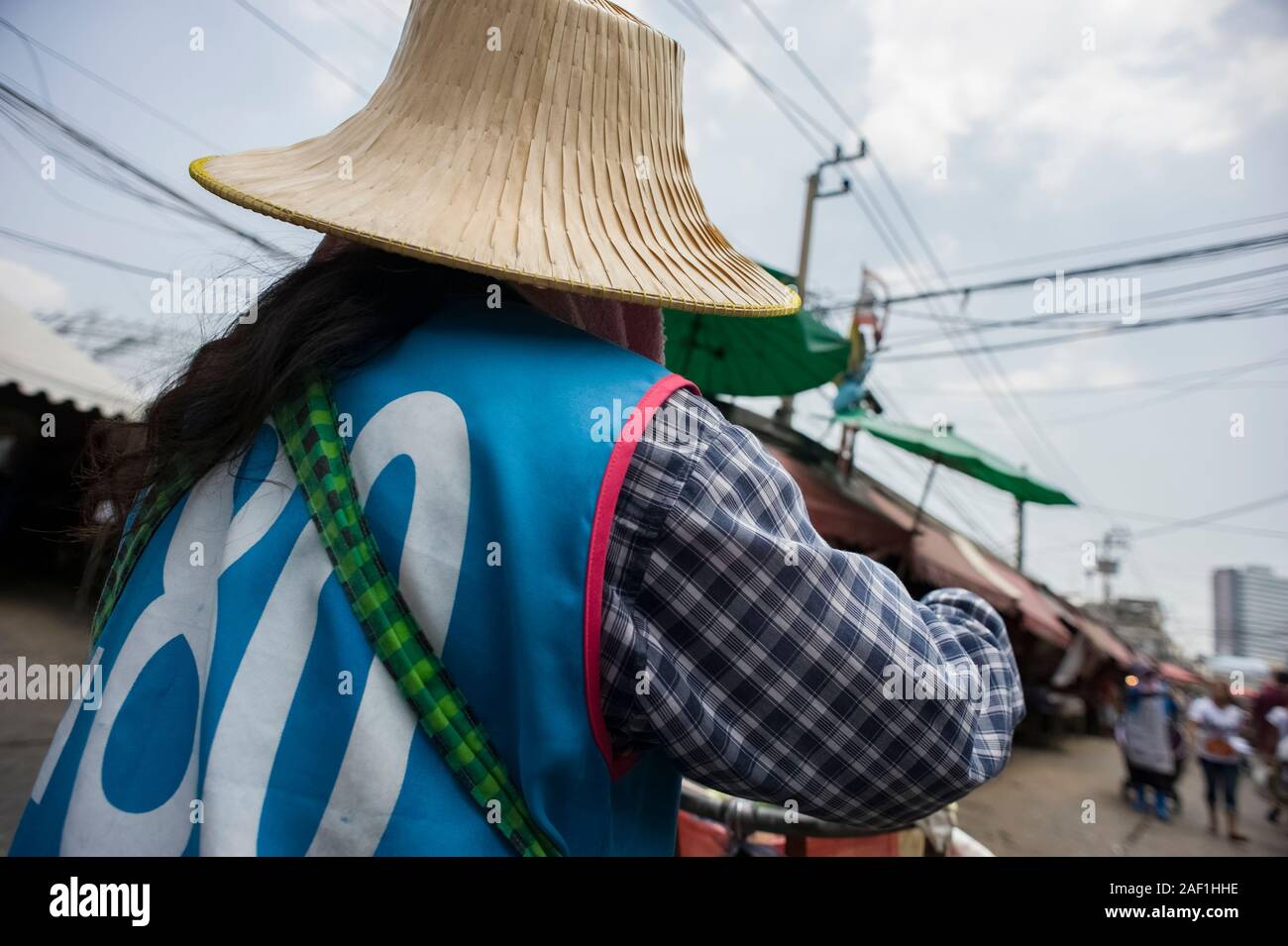 Bangkok, Thailand - April 18, 2011: Rear viewing of Thai woman at work in a street market of Khlong Toei Stock Photo