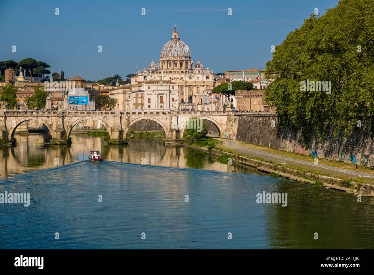 The Papal Basilica of St. Peter, St. Peter's Basilica and the bridge Ponte Sant'Angelo, seen across the river Tiber Stock Photo