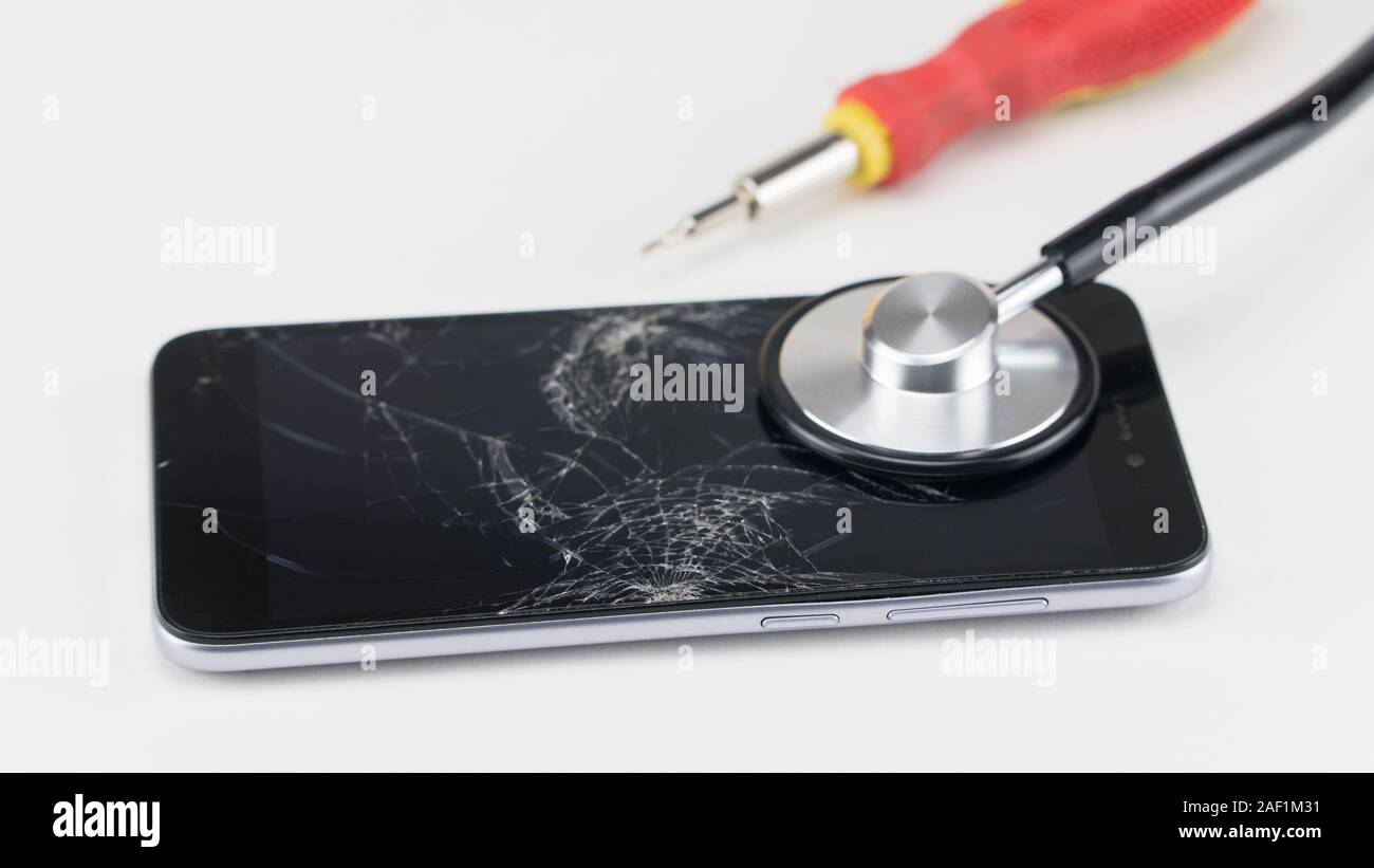Diagnosing the phone with a stethoscope, near a screwdriver. Phone