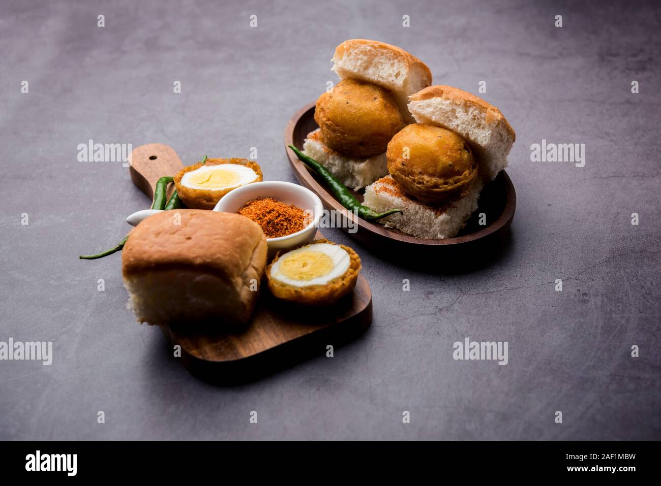 Egg Vada Pav or Anda  Wada Paav / Pao is a non-Vegetarian Fast Food Dish From Maharashtra, India Stock Photo