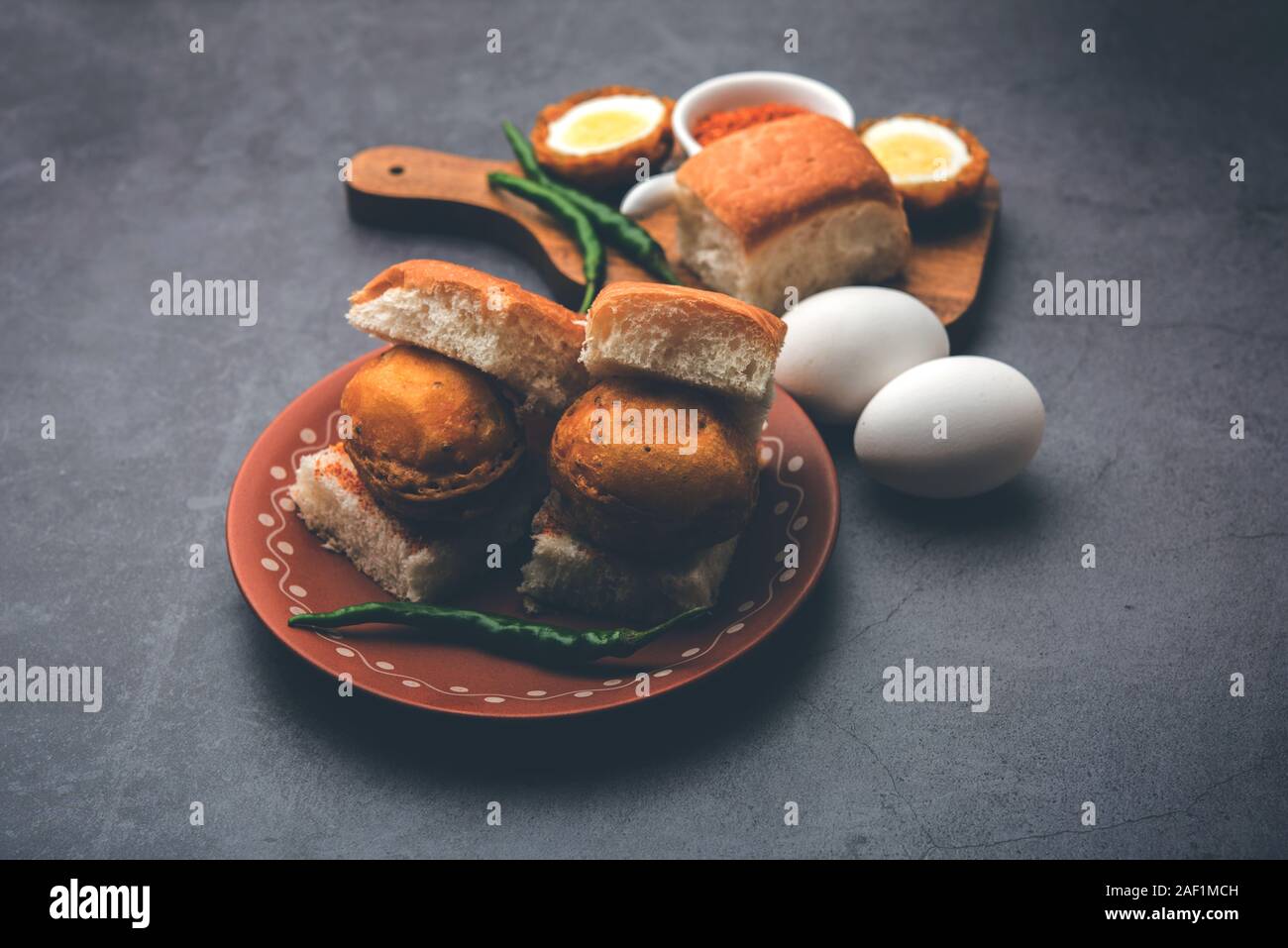 Egg Vada Pav or Anda  Wada Paav / Pao is a non-Vegetarian Fast Food Dish From Maharashtra, India Stock Photo