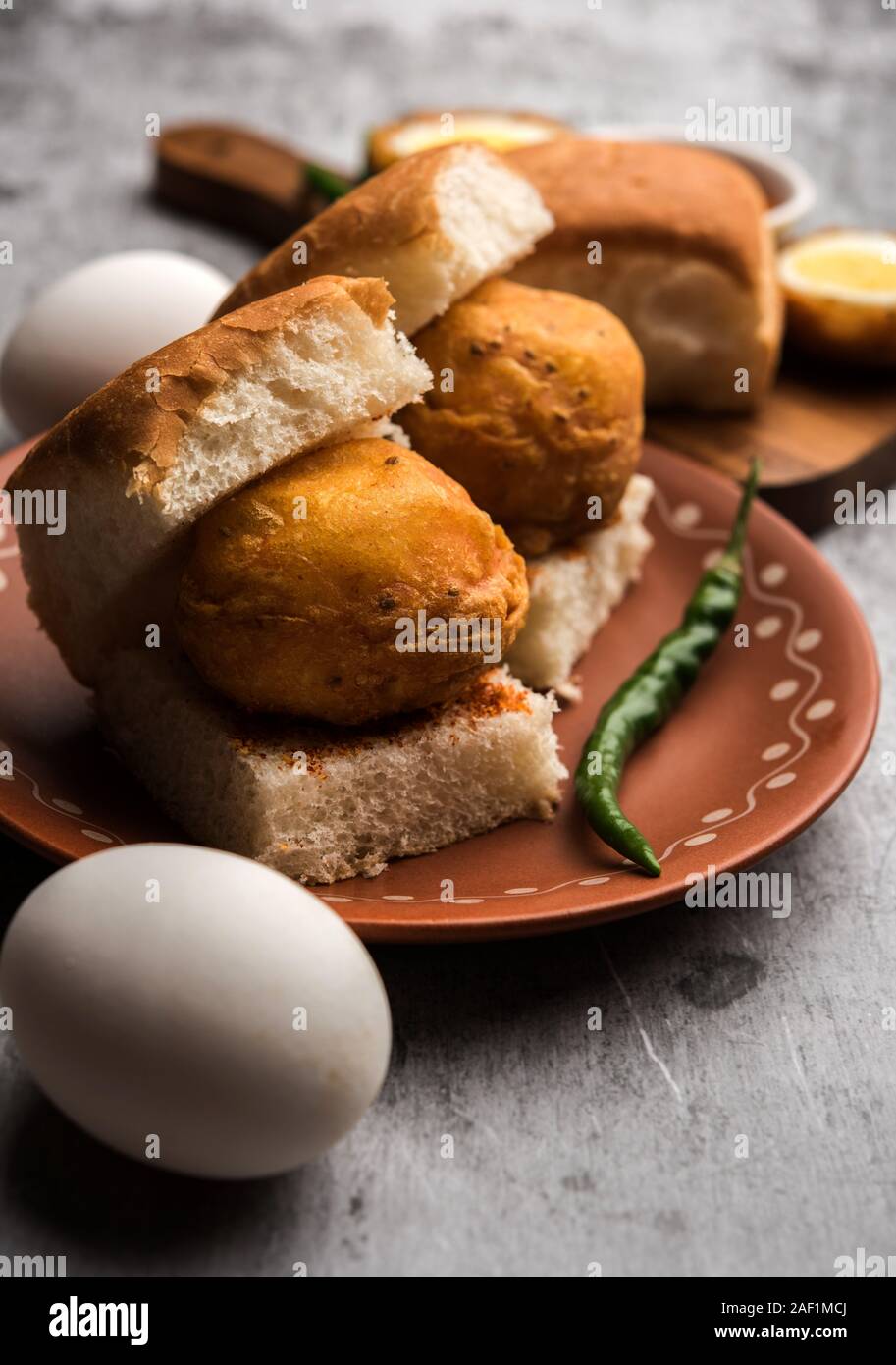 Egg Vada Pav or Anda  Wada Paav / Pao is a non-Vegetarian Fast Food Dish From Maharashtra, India Stock Photo