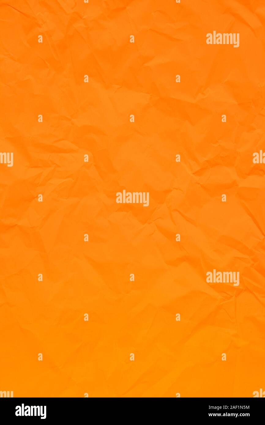 Orange crumpled wrinkled textured paper background. Empty space Stock Photo