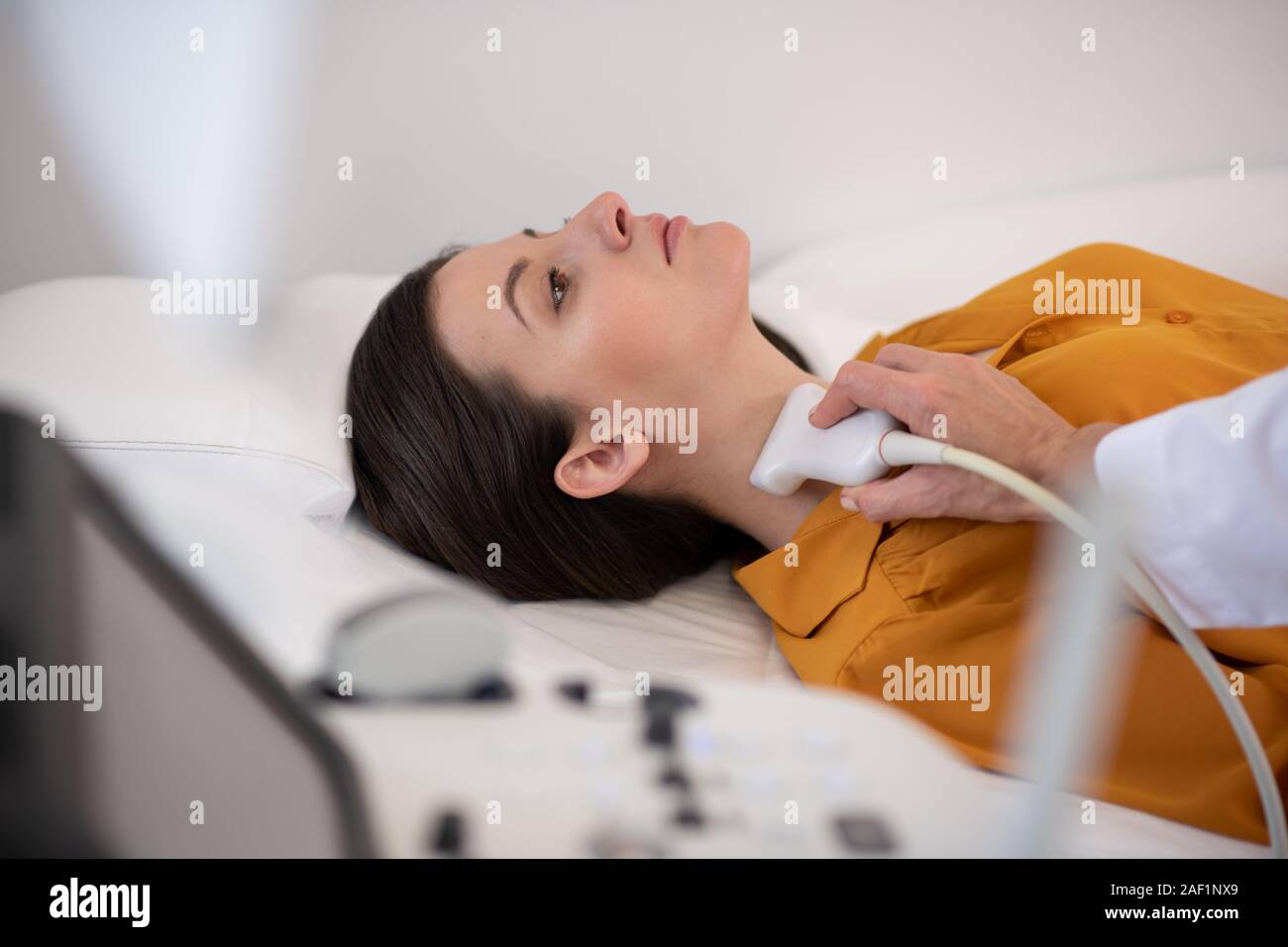 Doctor In Diagnostic Center Making Ultrasound Thyroid Gland Test Stock