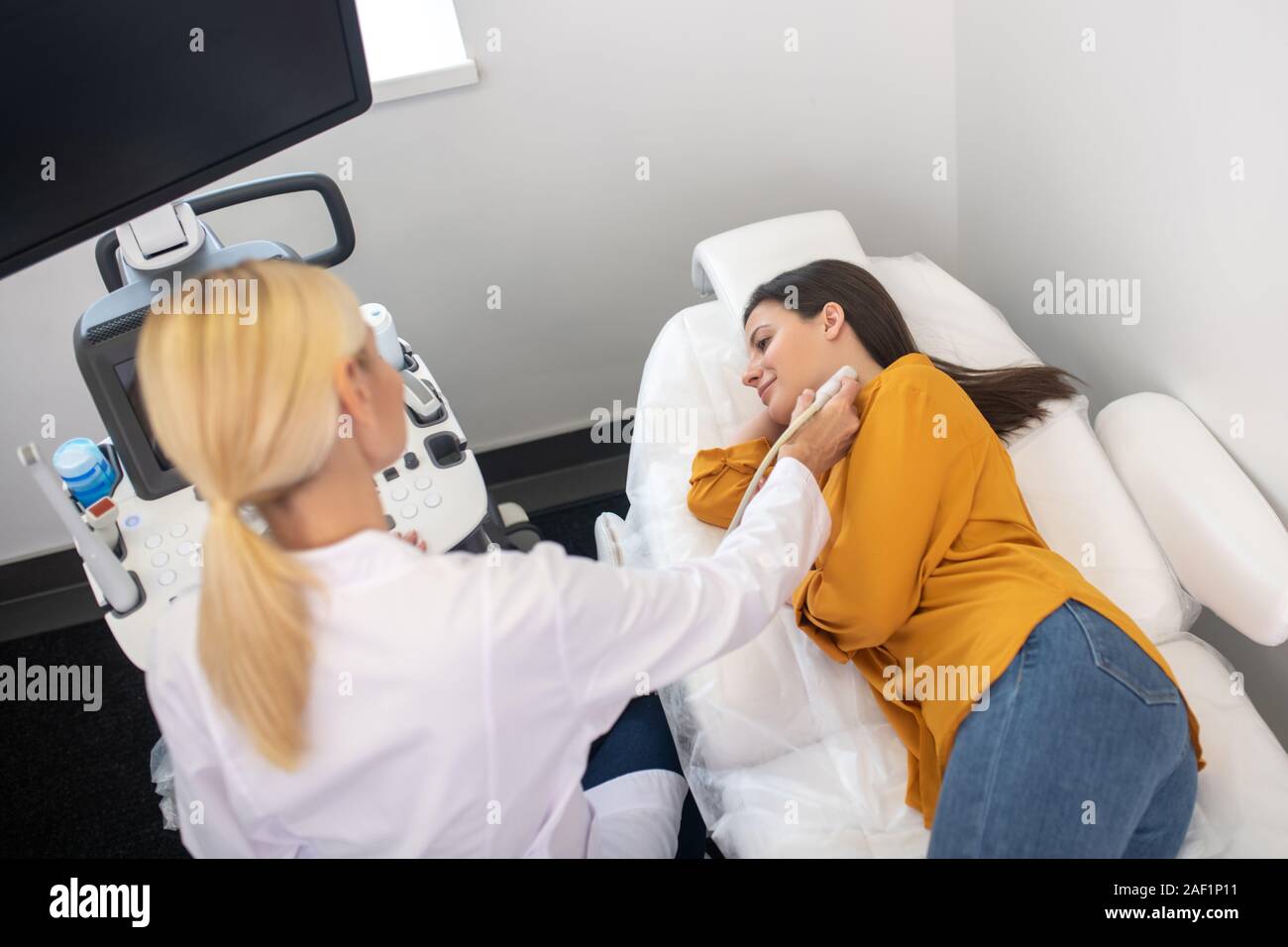 Ultrasound specialist in white robe making ultrasonic test Stock Photo Alamy