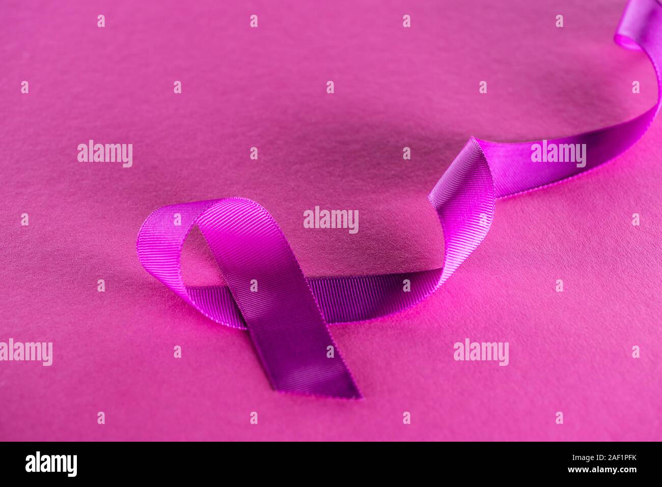 purple ribbon on pink background with shadow Stock Photo - Alamy