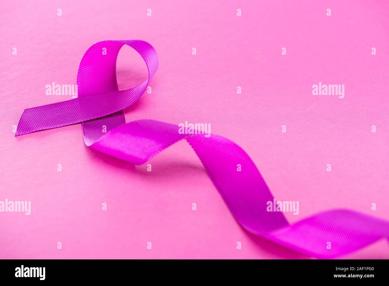 long purple ribbon on pink background Stock Photo - Alamy