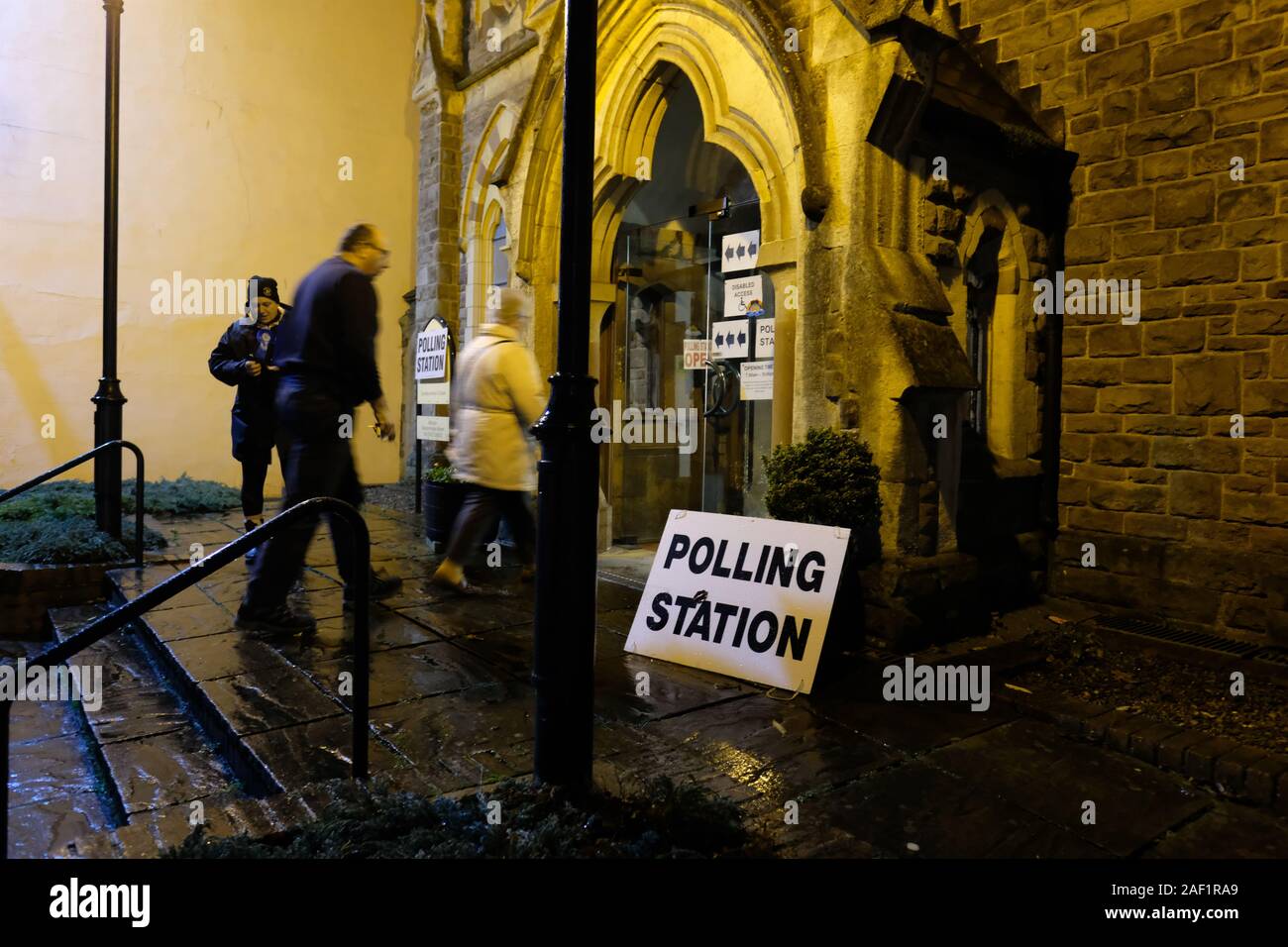 Hereford, Herefordshire, UK - Thursday 12th December 2019 - UK Election - Early morning voters arrive at a Polling Station in a church in Hereford on a cold dark and wet winter morning just after opening at 7AM. Photo Steven May / Alamy Live News Stock Photo
