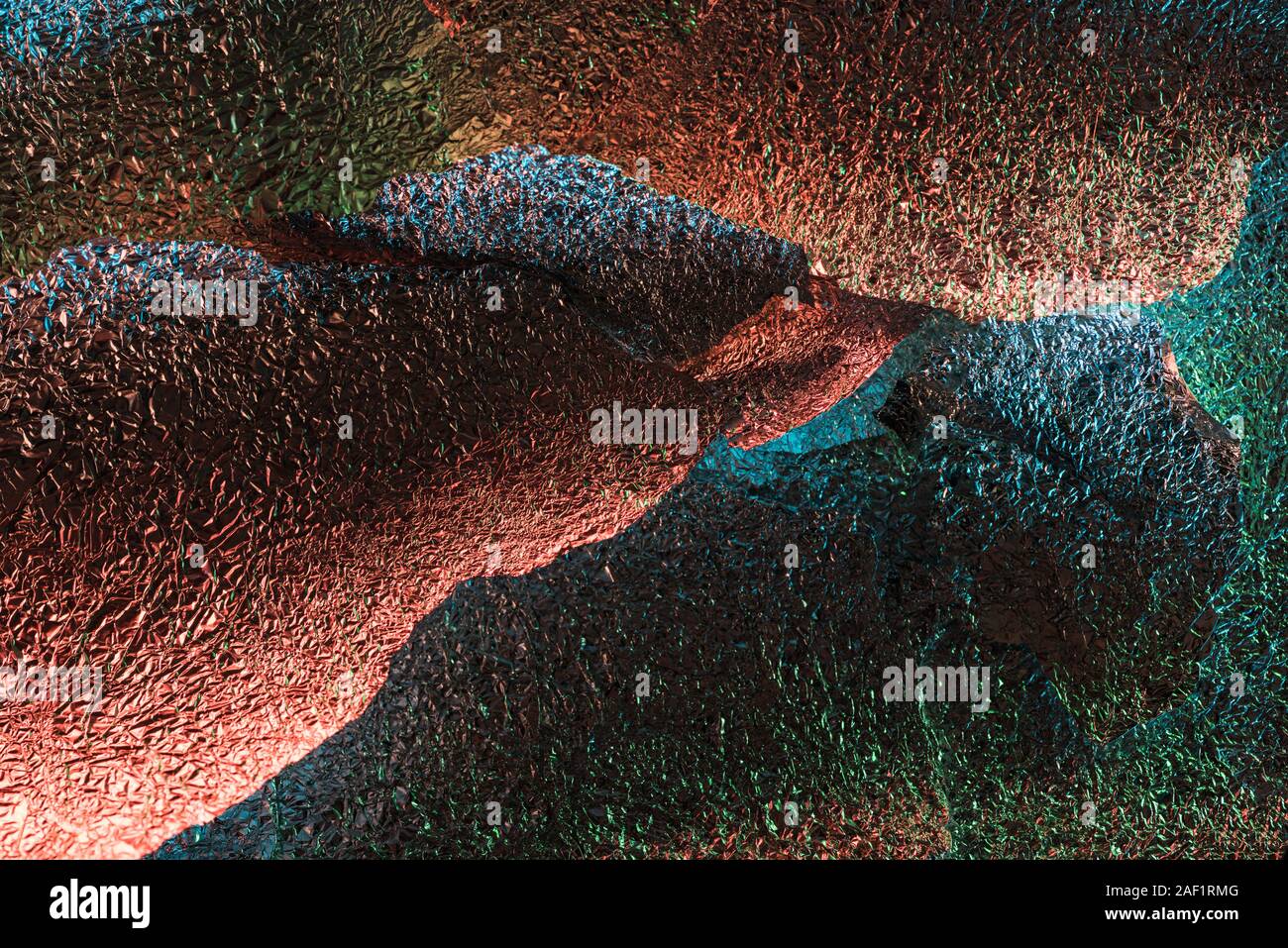 abstract background of shiny textured ragged foil with colorful ...