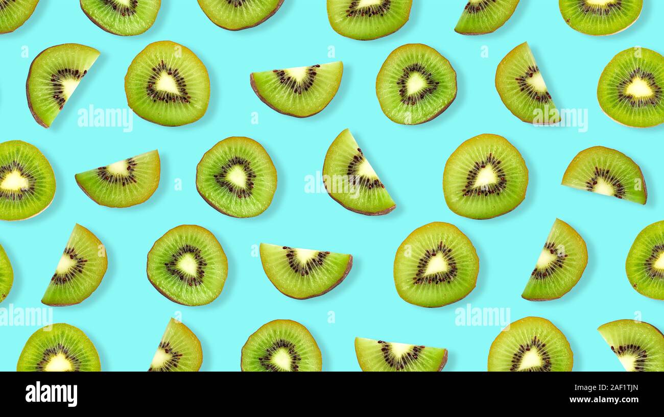 Kiwi fruit Slices macro. Ripe Kiwi fruit isolated on blue background. Stock Photo