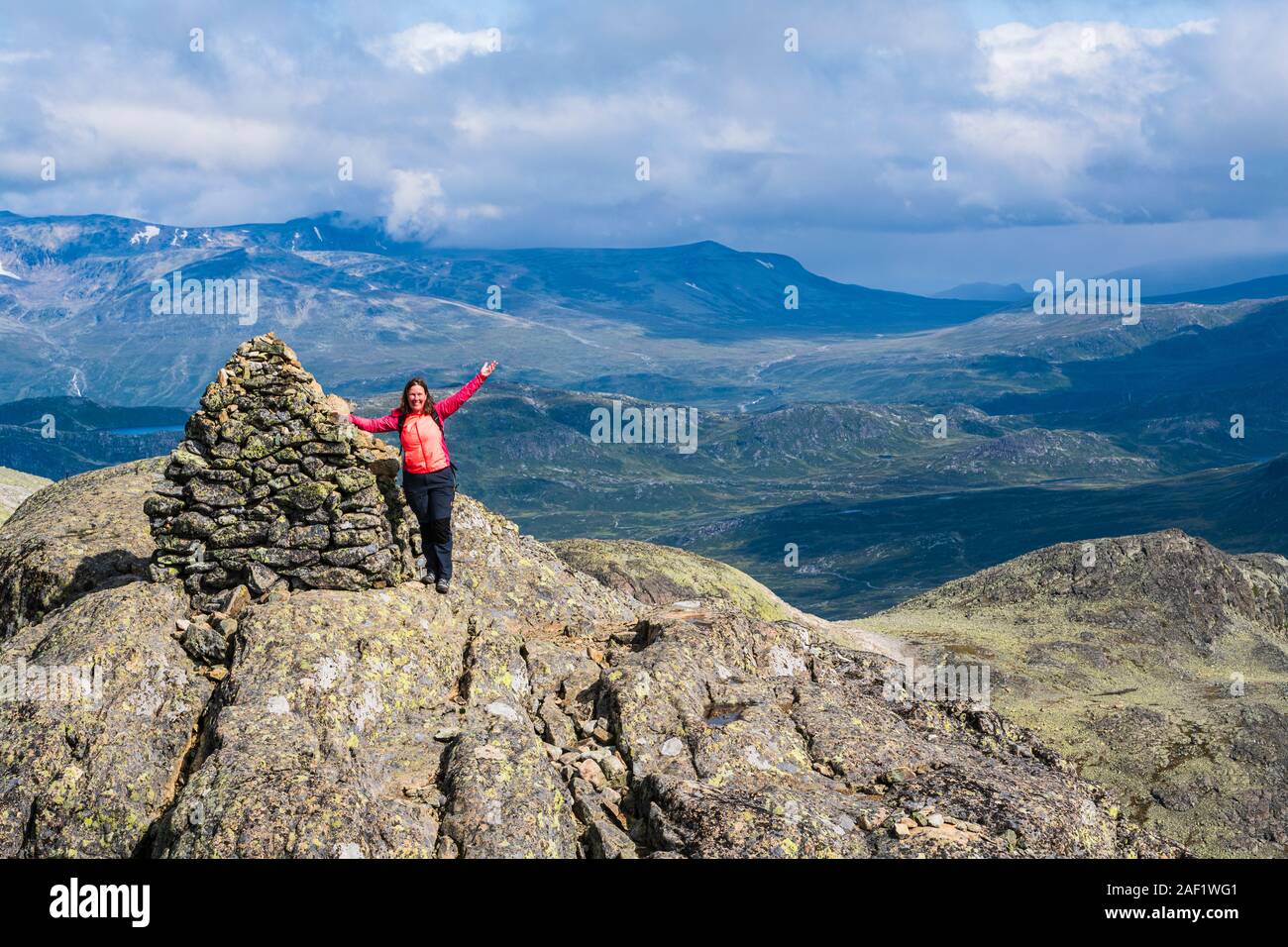 Woman on top of mountain Stock Photo