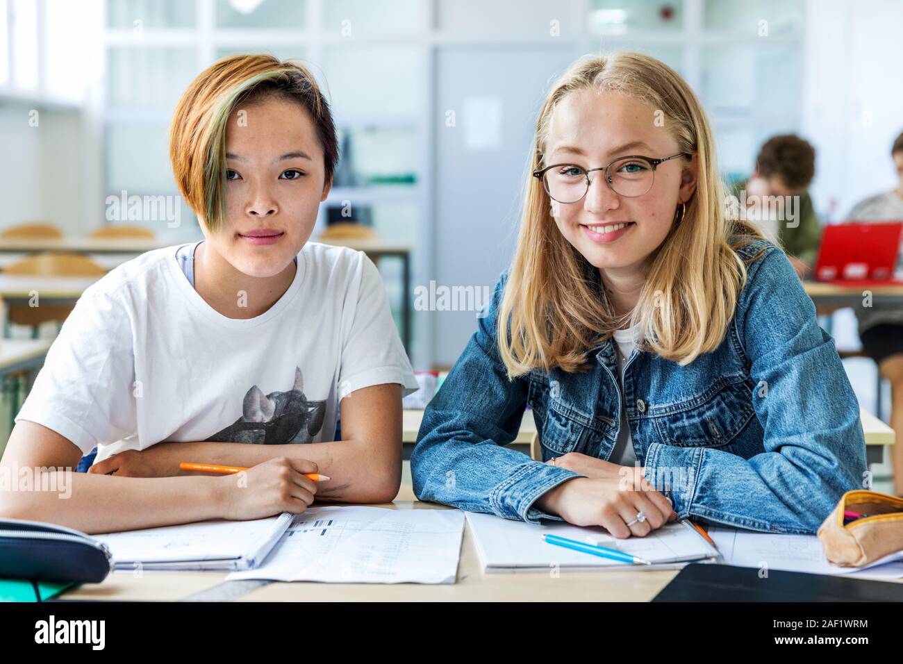 Teenage girls in classroom Stock Photo - Alamy