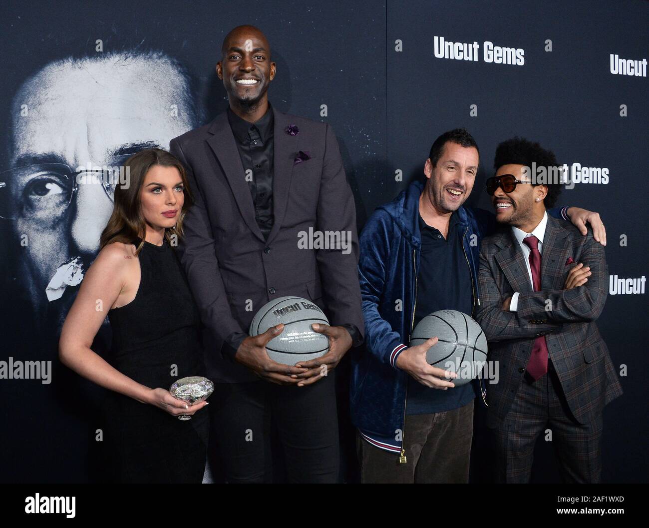 Hollywood, California, USA. 12th Dec, 2019. Cast members Julia Fox, Kevin Garnett. Adam Sandler and The Weekend (L-R) attend the premiere of the motion picture crime thriller 'Uncut Gems' at the ArcLight Cinema Dome in the Hollywood section of Los Angeles on Wednesday, December 11, 2019. Storyline: Howard Ratner (Adam Sandler), a charismatic New York City jeweler always on the lookout for the next big score. Credit: UPI/Alamy Live News Stock Photo