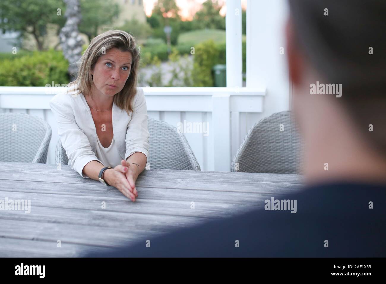 Woman talking on terrace Stock Photo