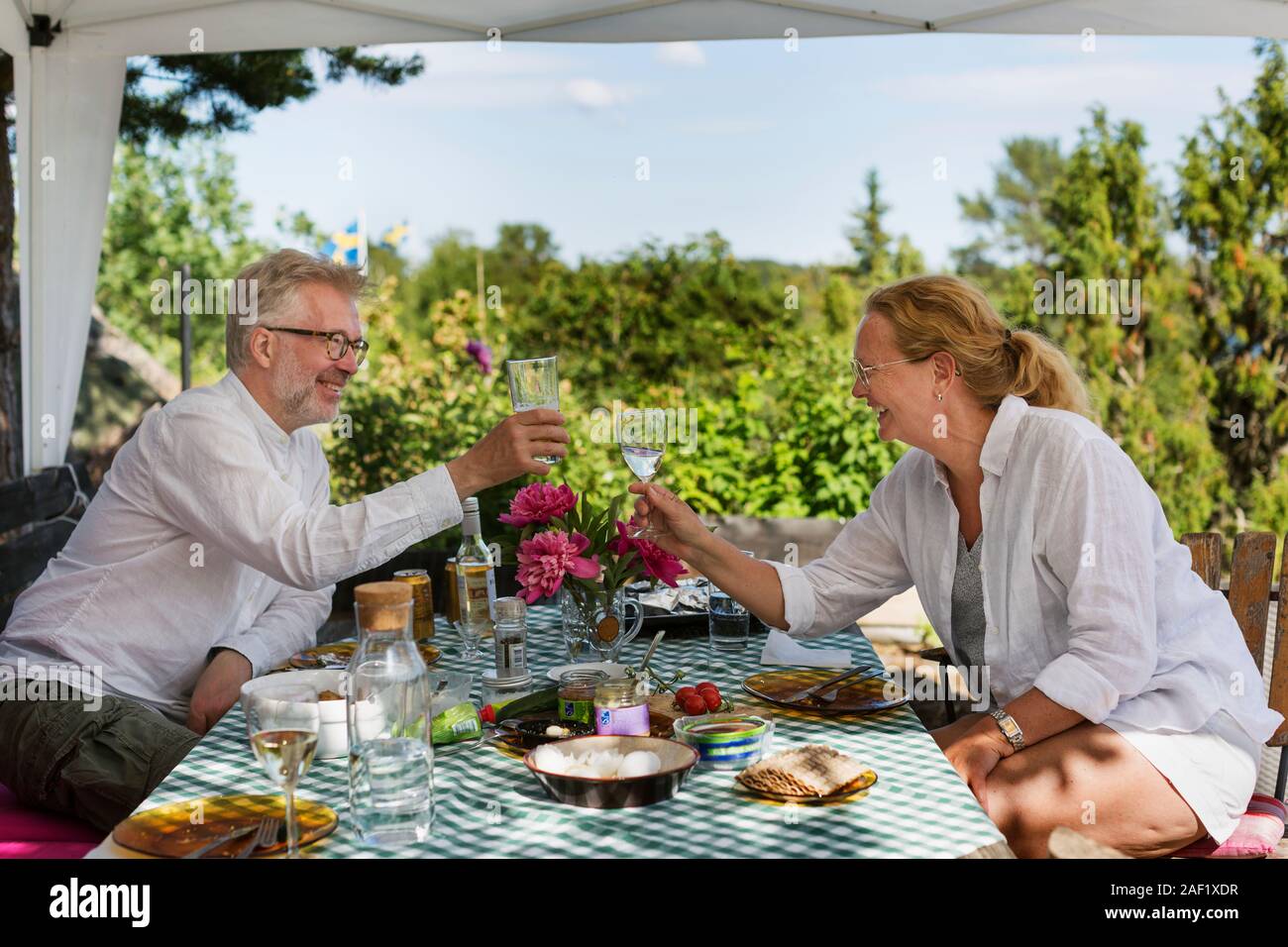 Mature couple having meal in garden Stock Photo