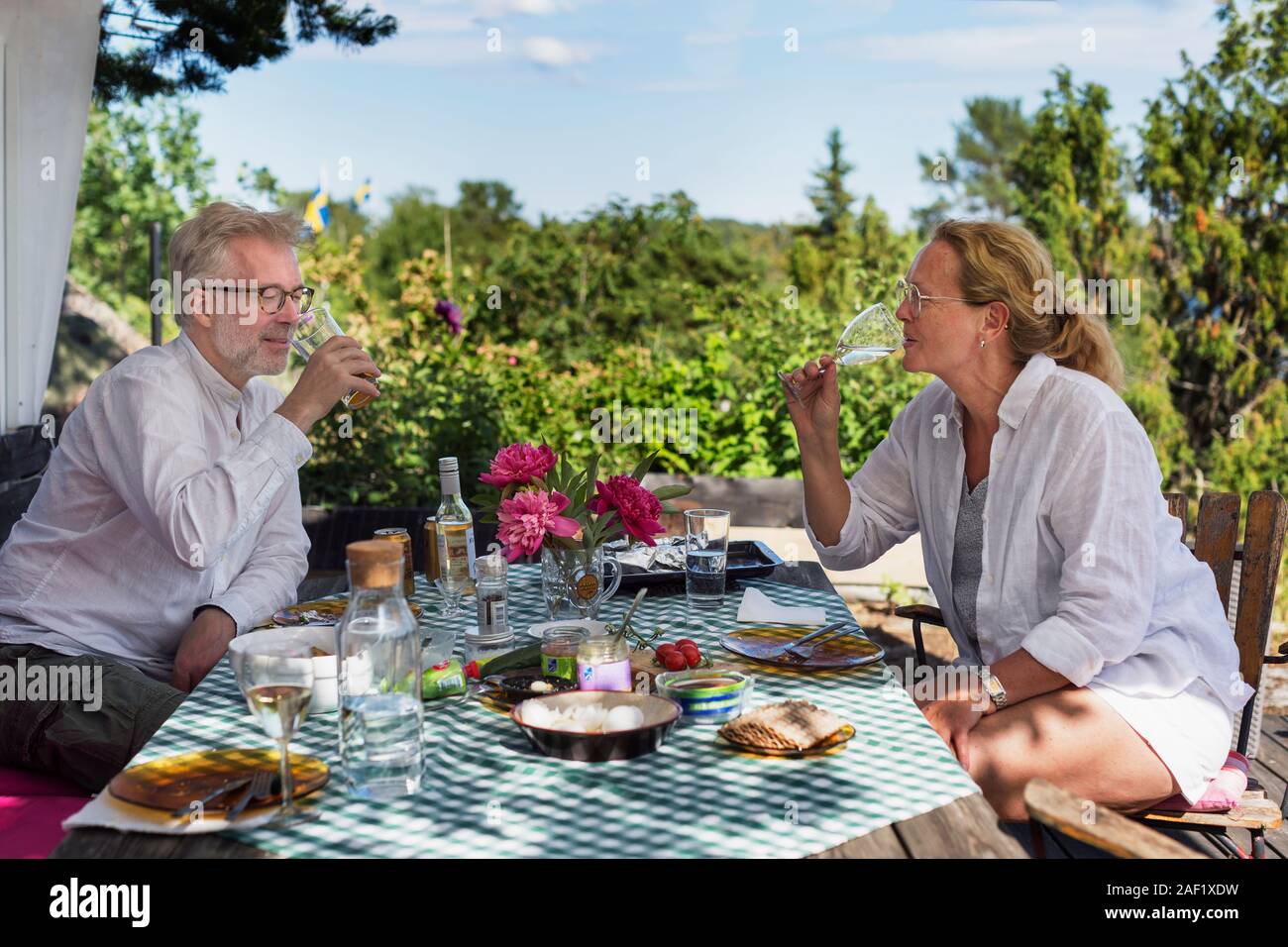 Mature couple having meal in garden Stock Photo