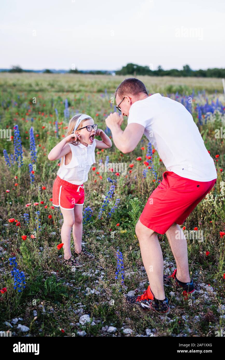 Father and daughter making faces Stock Photo