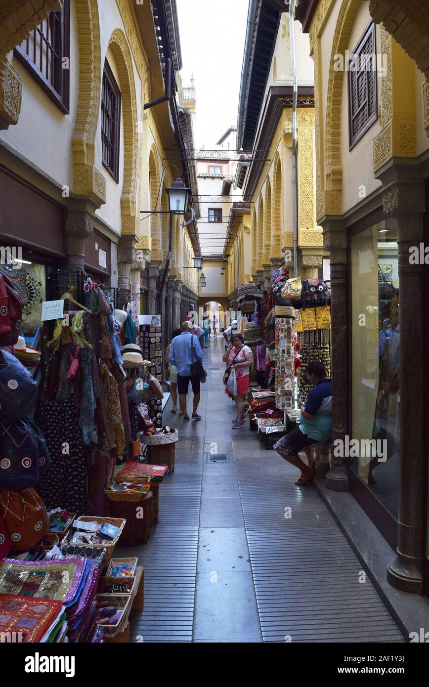 Narrow street lined with shops in Granada, Spain Stock Photo Alamy