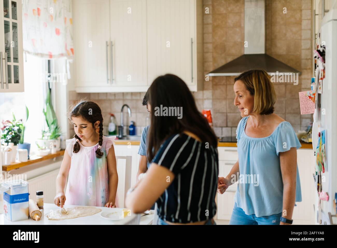 Mother with children in kitchen Stock Photo