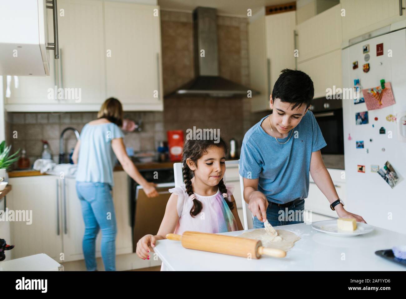 Brother and sister baking in kitchen Stock Photo