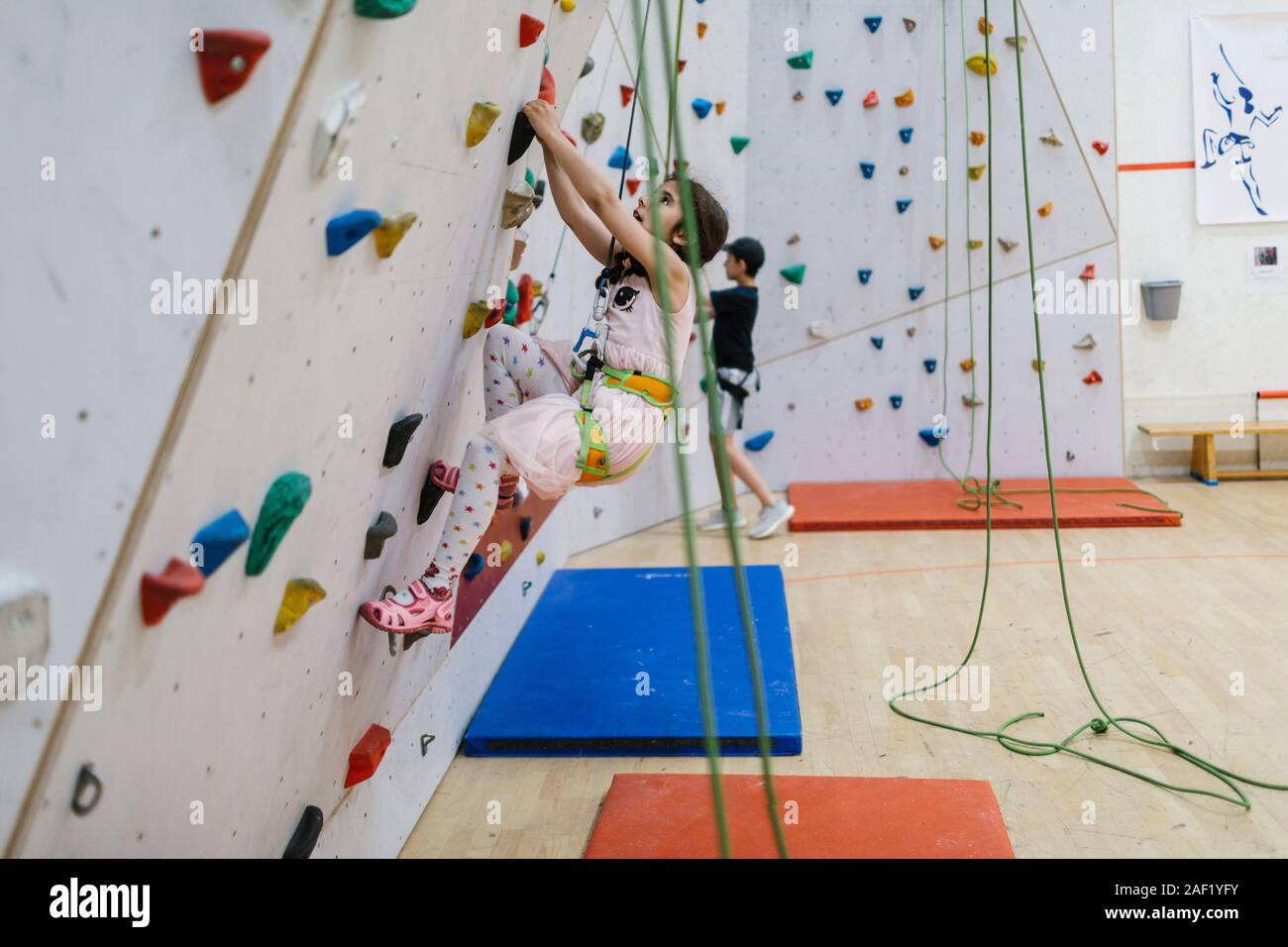 Girl on climbing wall Stock Photo