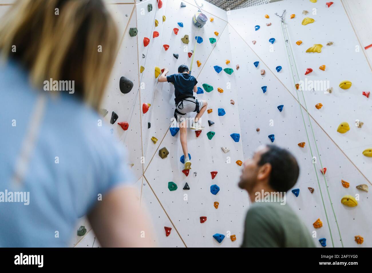 Boy on climbing wall Stock Photo - Alamy