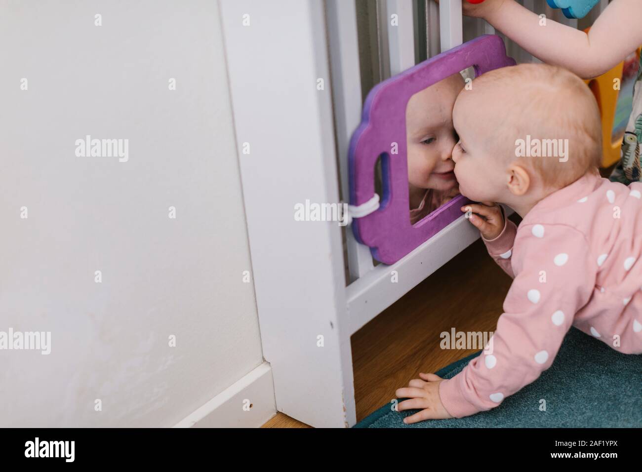 Toddler girl kissing mirror Stock Photo Alamy