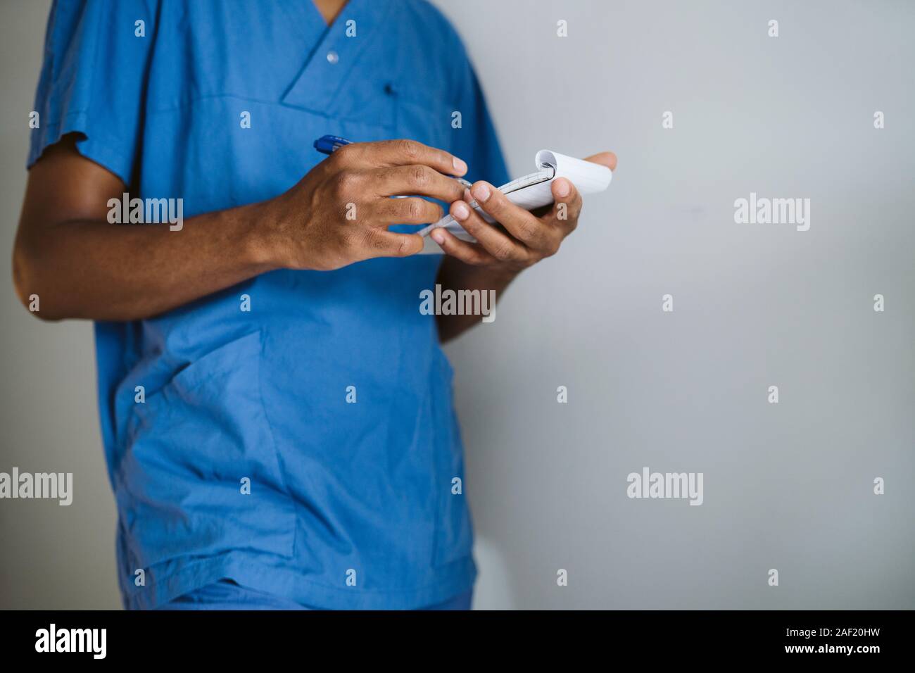 Doctor wearing scrubs and working hires stock photography and images