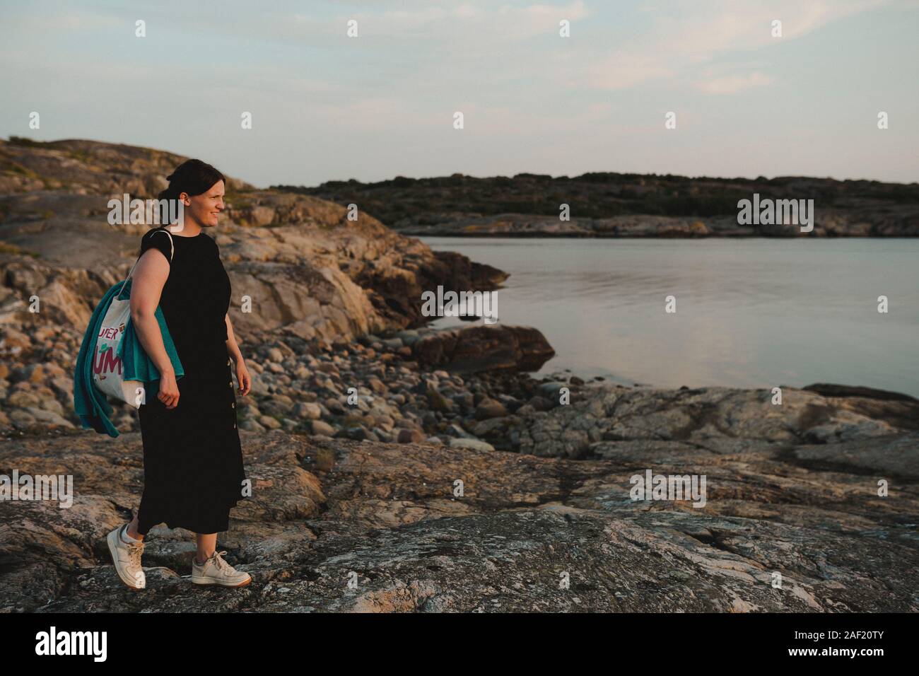 Woman standing rocky cliff hi-res stock photography and images - Alamy