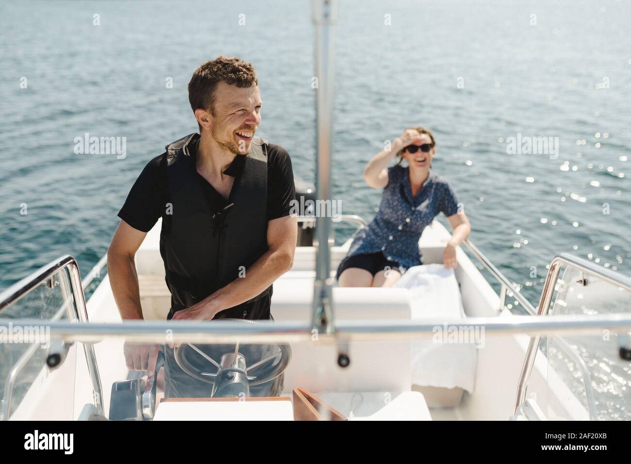 Man steering boat hi-res stock photography and images - Alamy