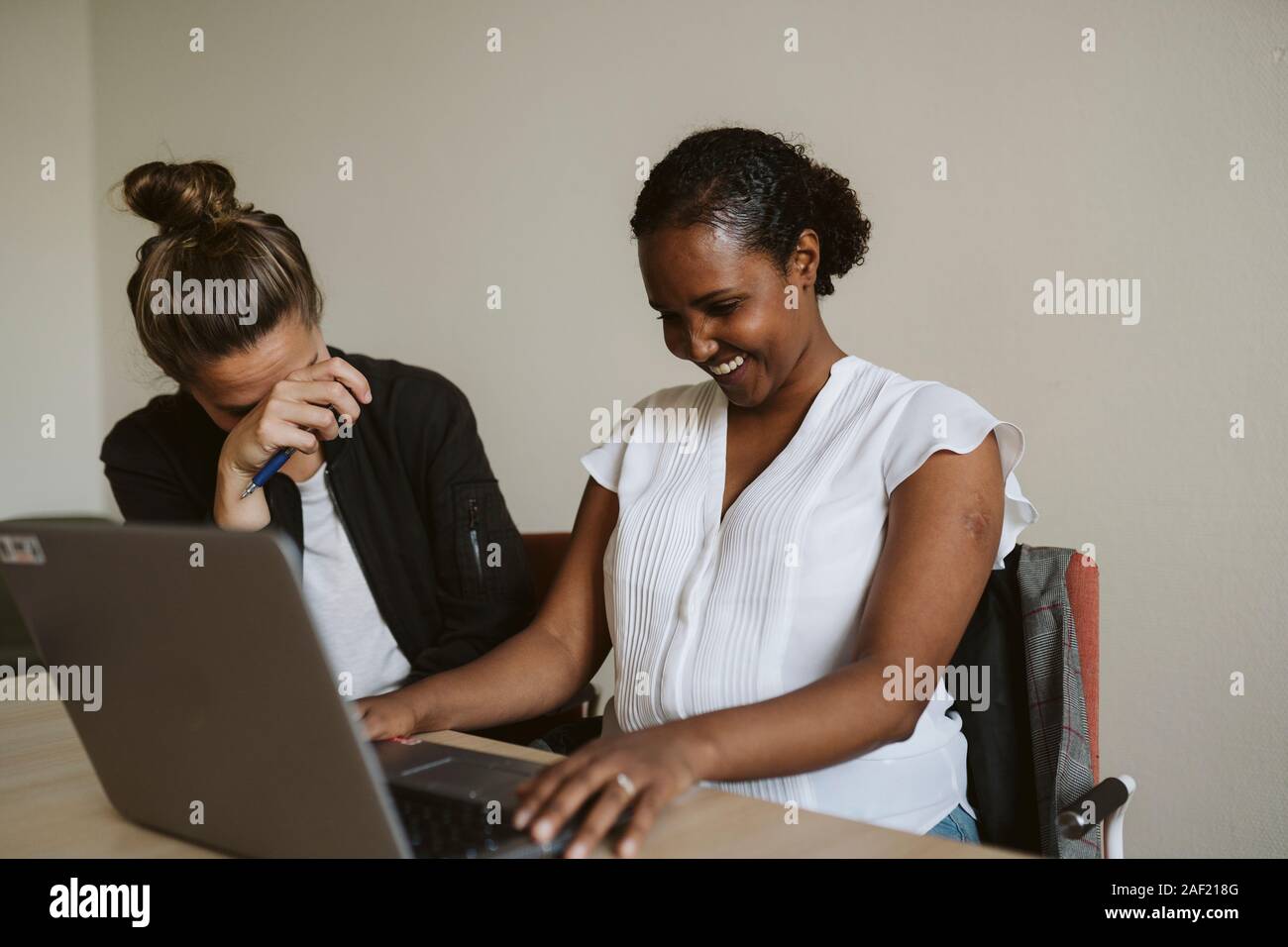 Smiling women using laptop Stock Photo
