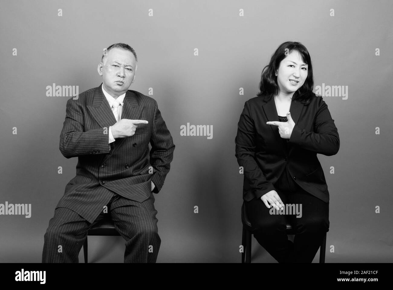 Mature Asian businessman and mature Asian businesswoman together Stock Photo
