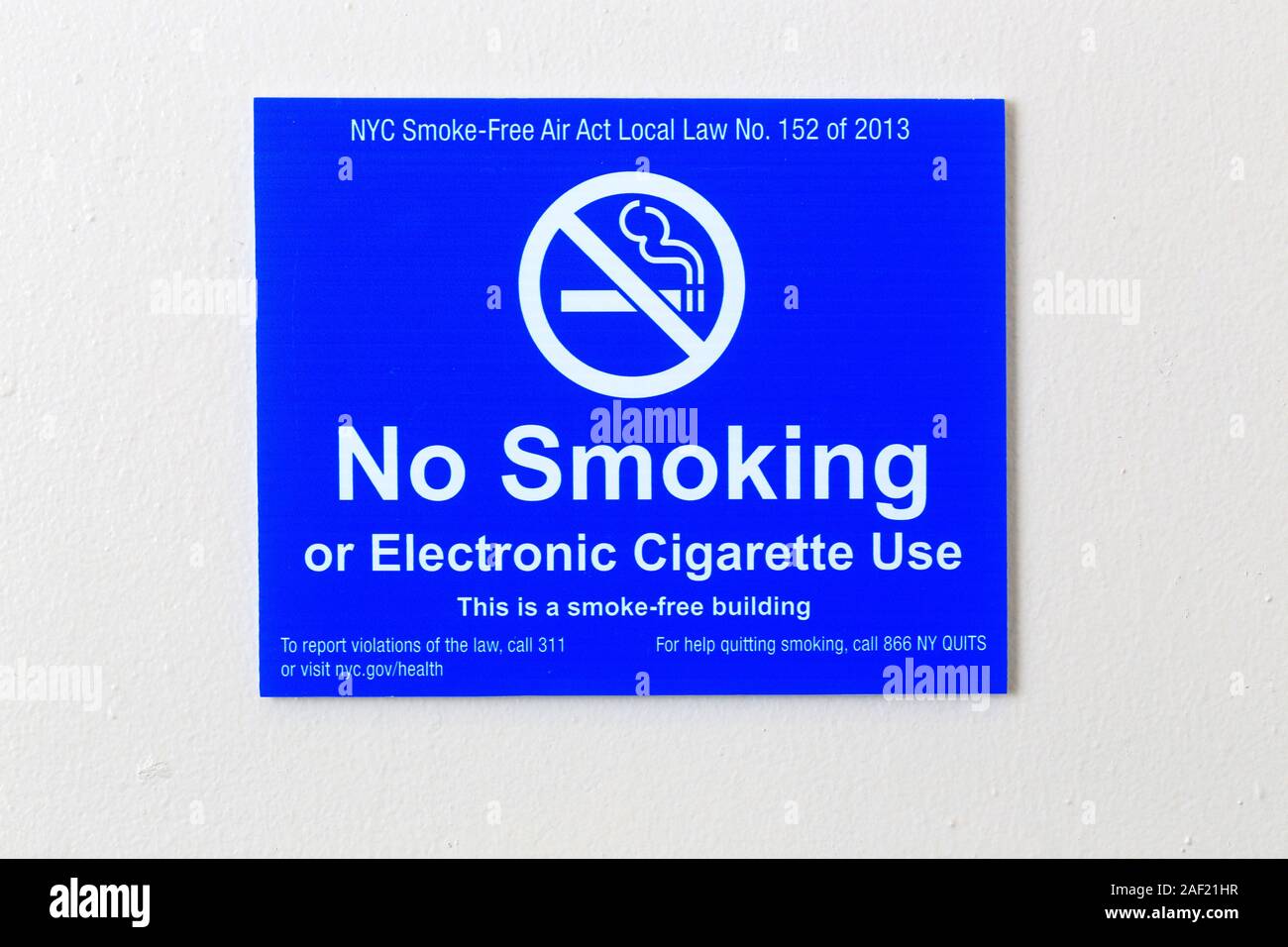 A No Smoking, No Electronic Cigarette Usage sign on a white painted wall inside a NYC building. Stock Photo