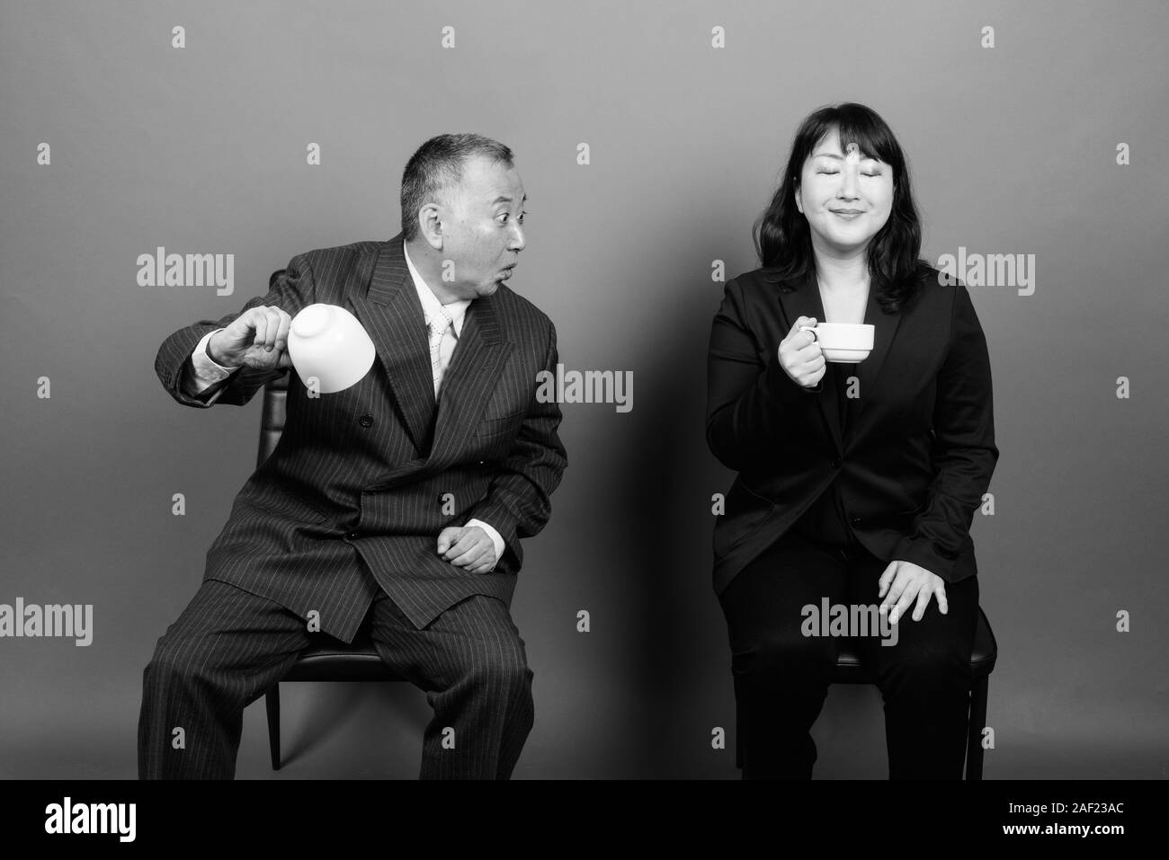 Mature Asian businessman and mature Asian businesswoman together Stock