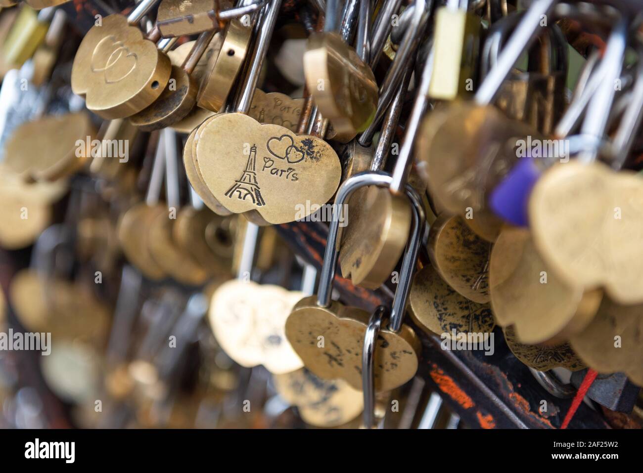 Paris (France): Love Padlock with an Eiffel Tower, a heart and the word Paris attached to a grid Stock Photo