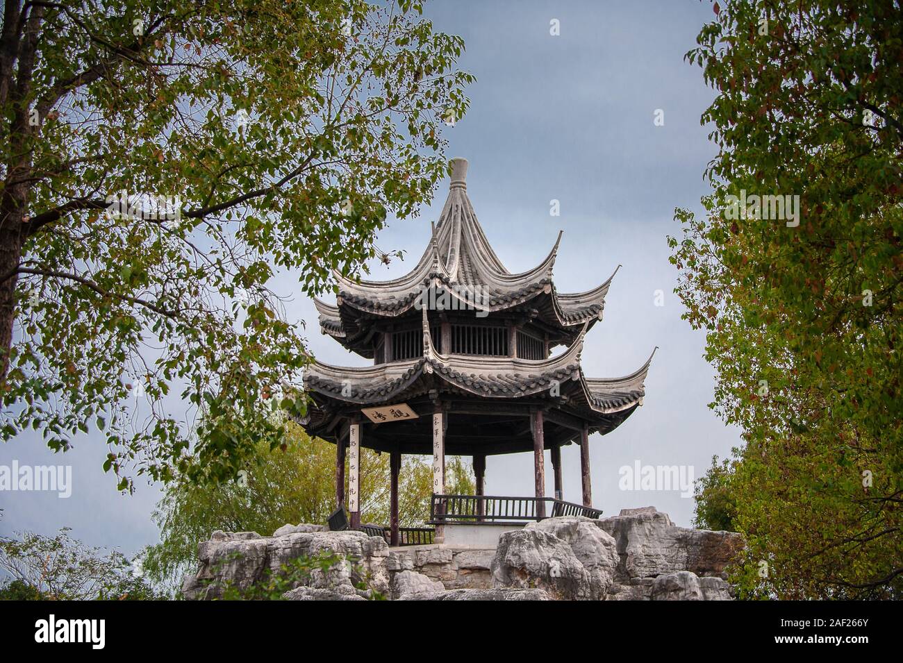 Wux, China - October 2019: Traditional Chinese style garden pavillion on a rocky mound.  Jiangsu Province, China Stock Photo