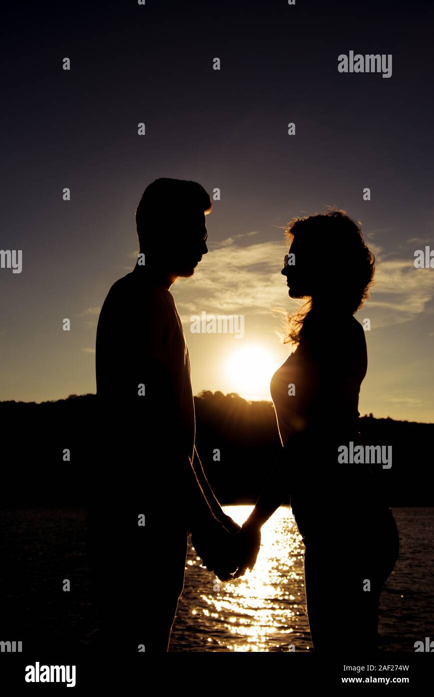 Silhouette Of Romantic Happy Couple In Love Holding Hands On The Sunset Stock Photo Alamy Silhouette Of Romantic Happy Couple In Love Holding Hands On The Sunset Stock Photo Alamy